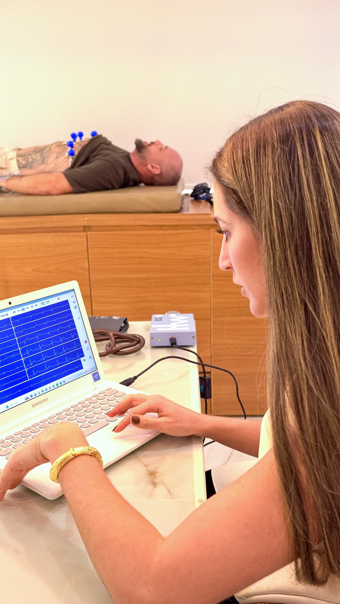 Dra. Verônica analisando o traçado do eletrocardiograma durante o exame
